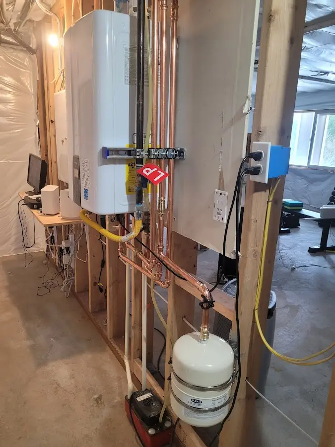 Licensed plumber repairing a kitchen sink in Colona